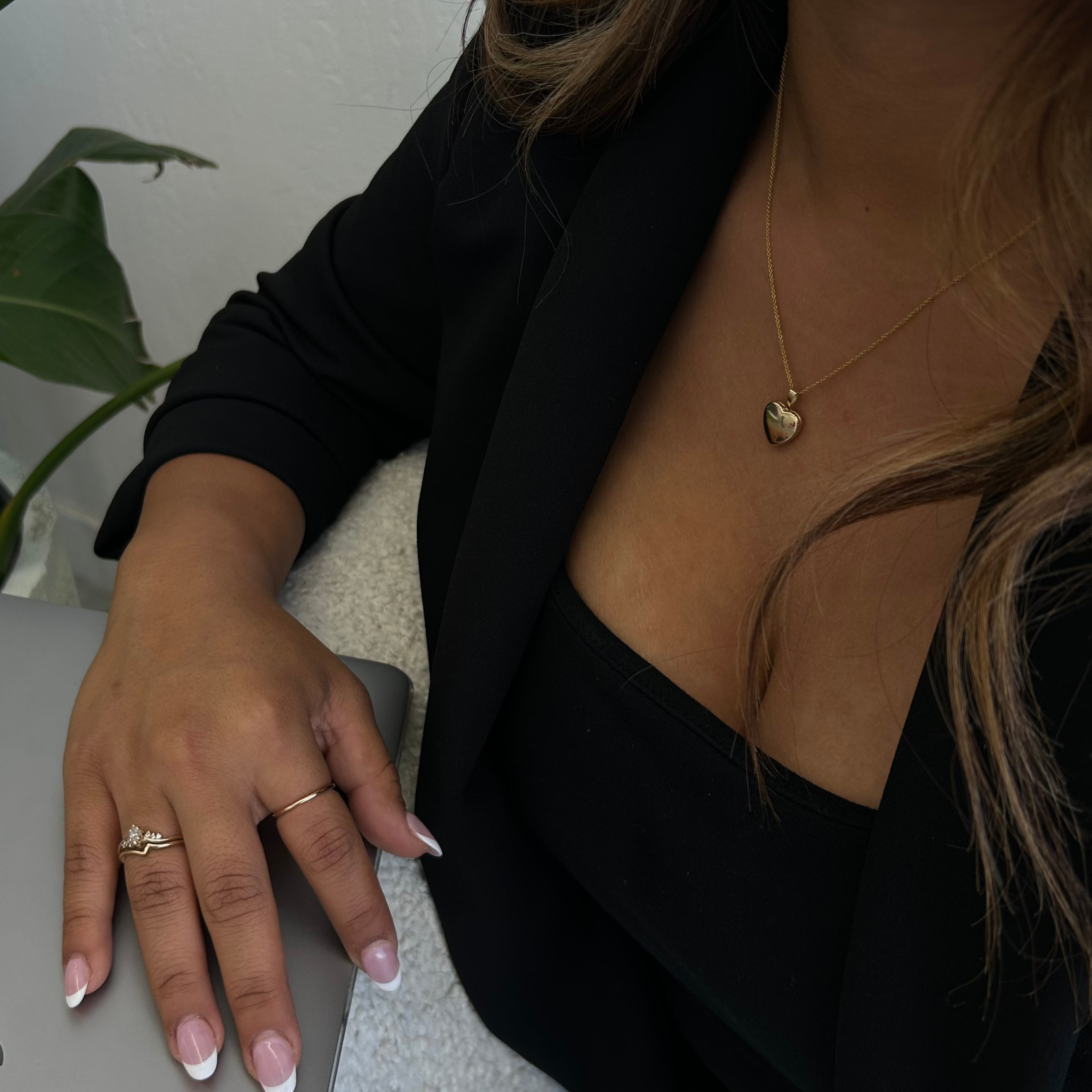 image of a woman wearing a 14k gold heart locket necklace