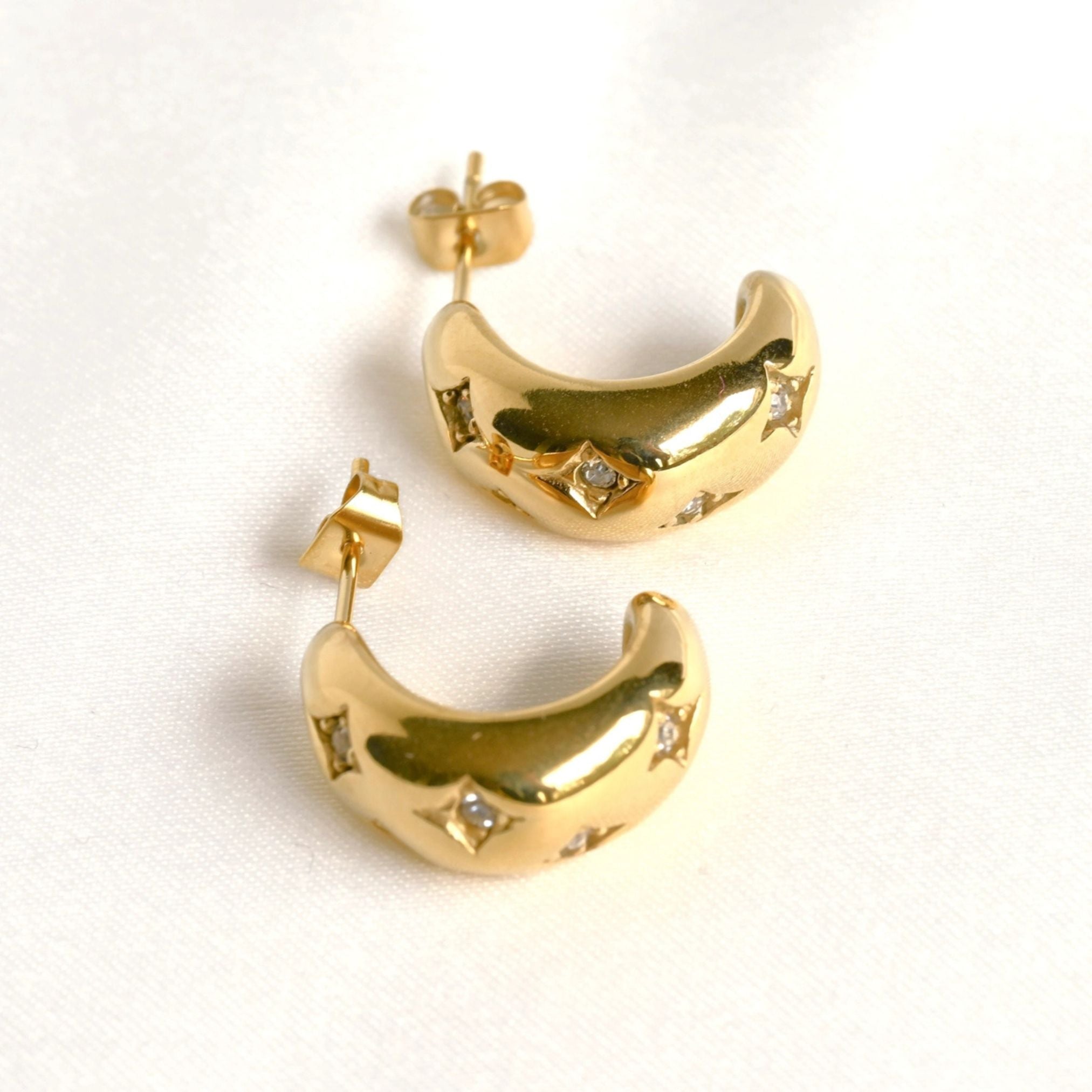 image of two gold earrings