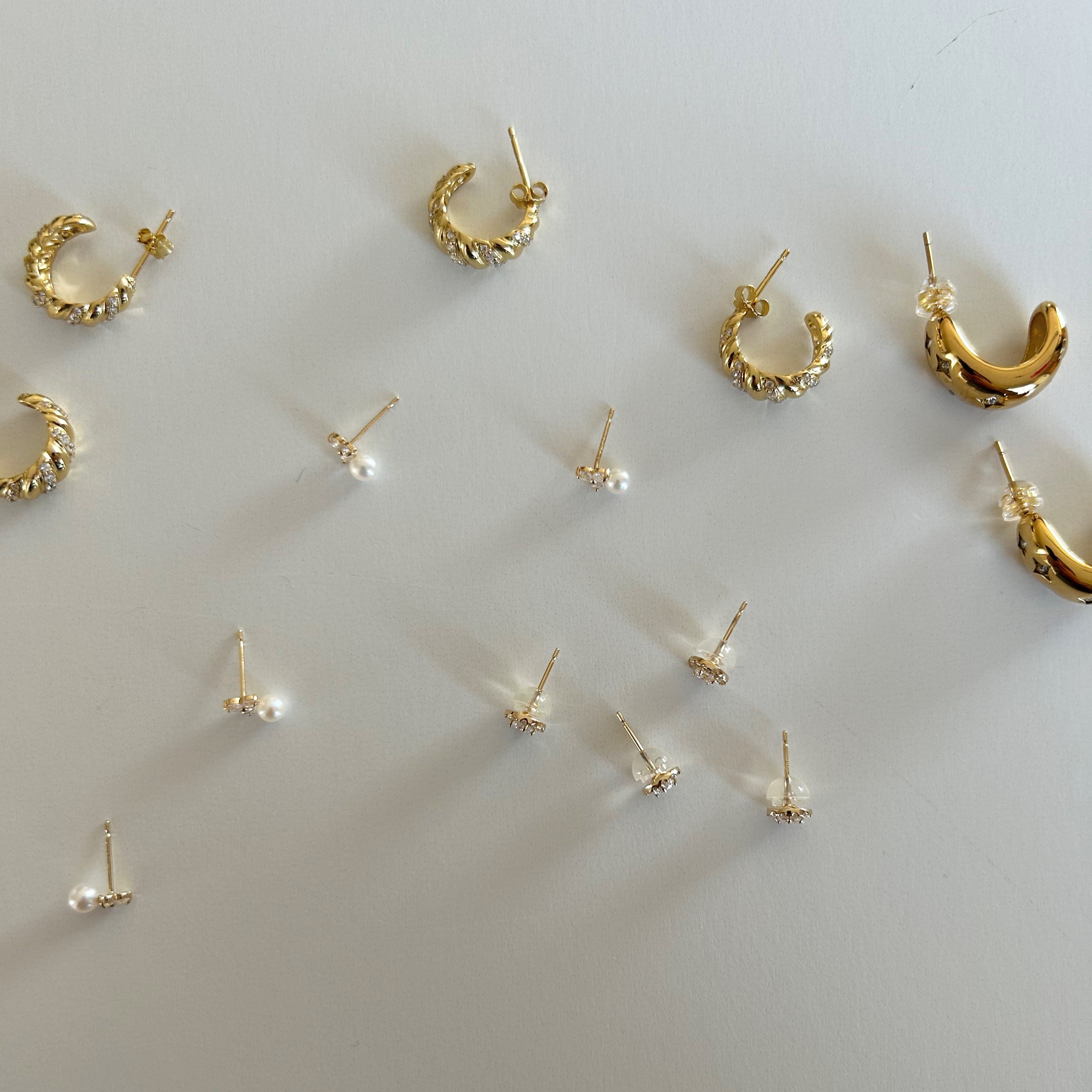 image of multiple earrings on a white backdrop