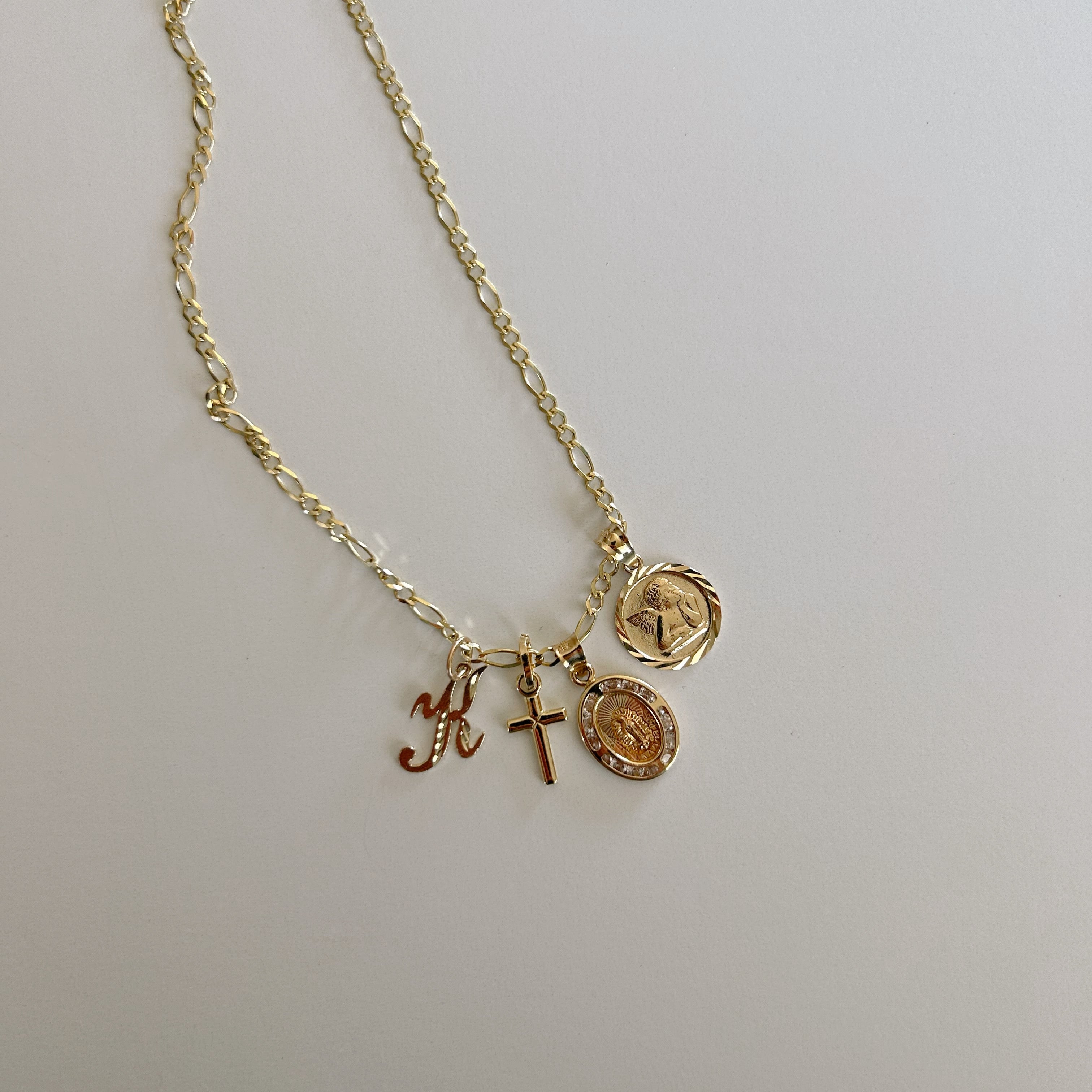 image of multiple gold pendant charms on a gold necklace