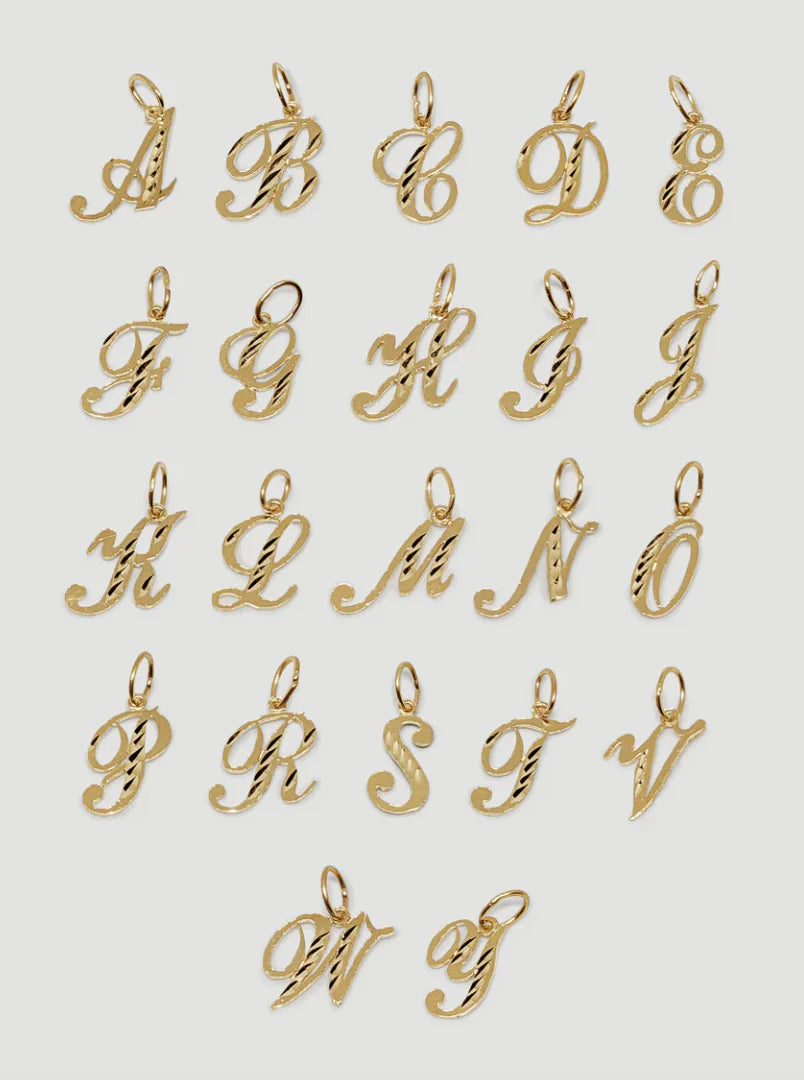 Gold letter pendants on a white background