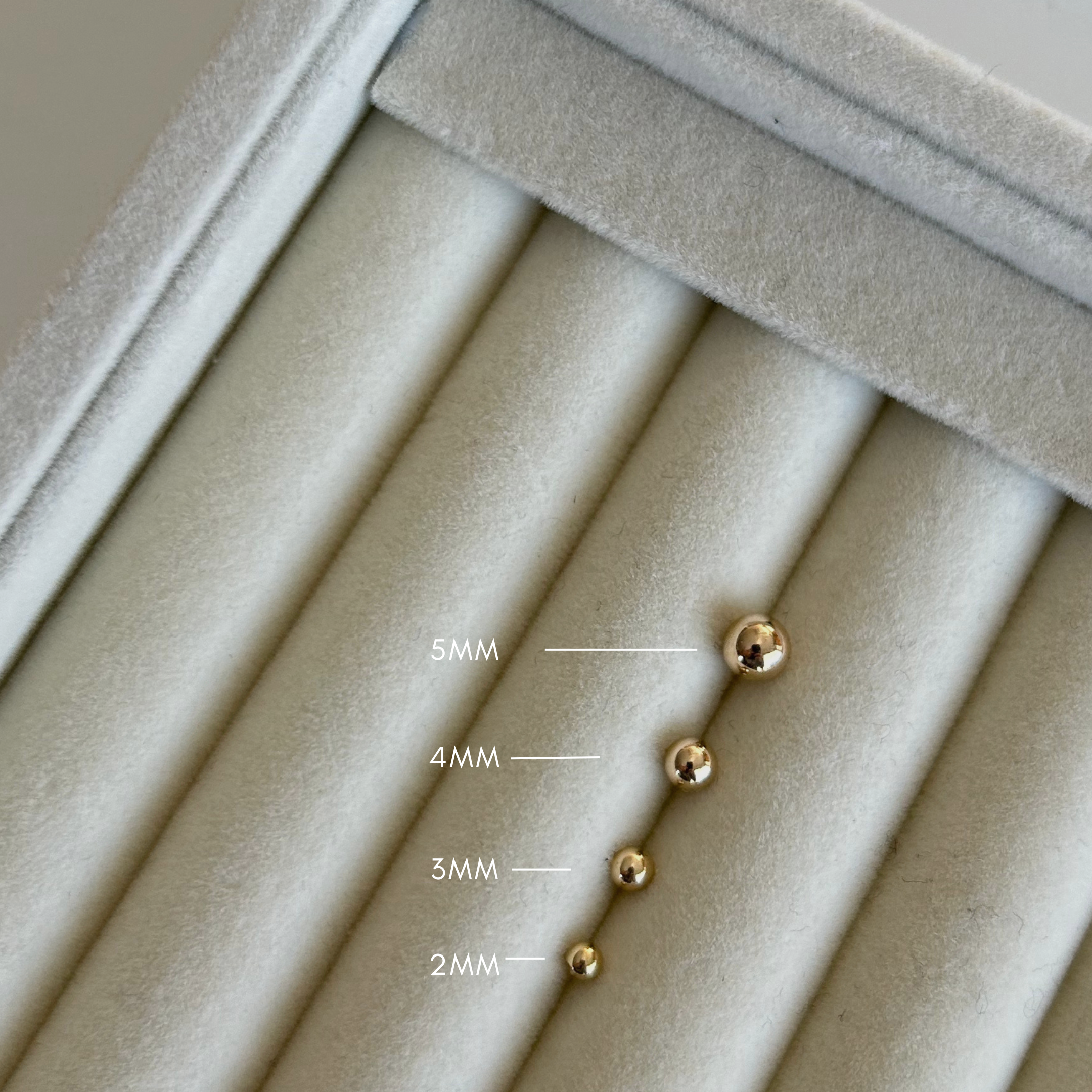 image of 14K ball studs on a white backdrop