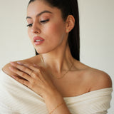 Woman in a white dress lying on a white background