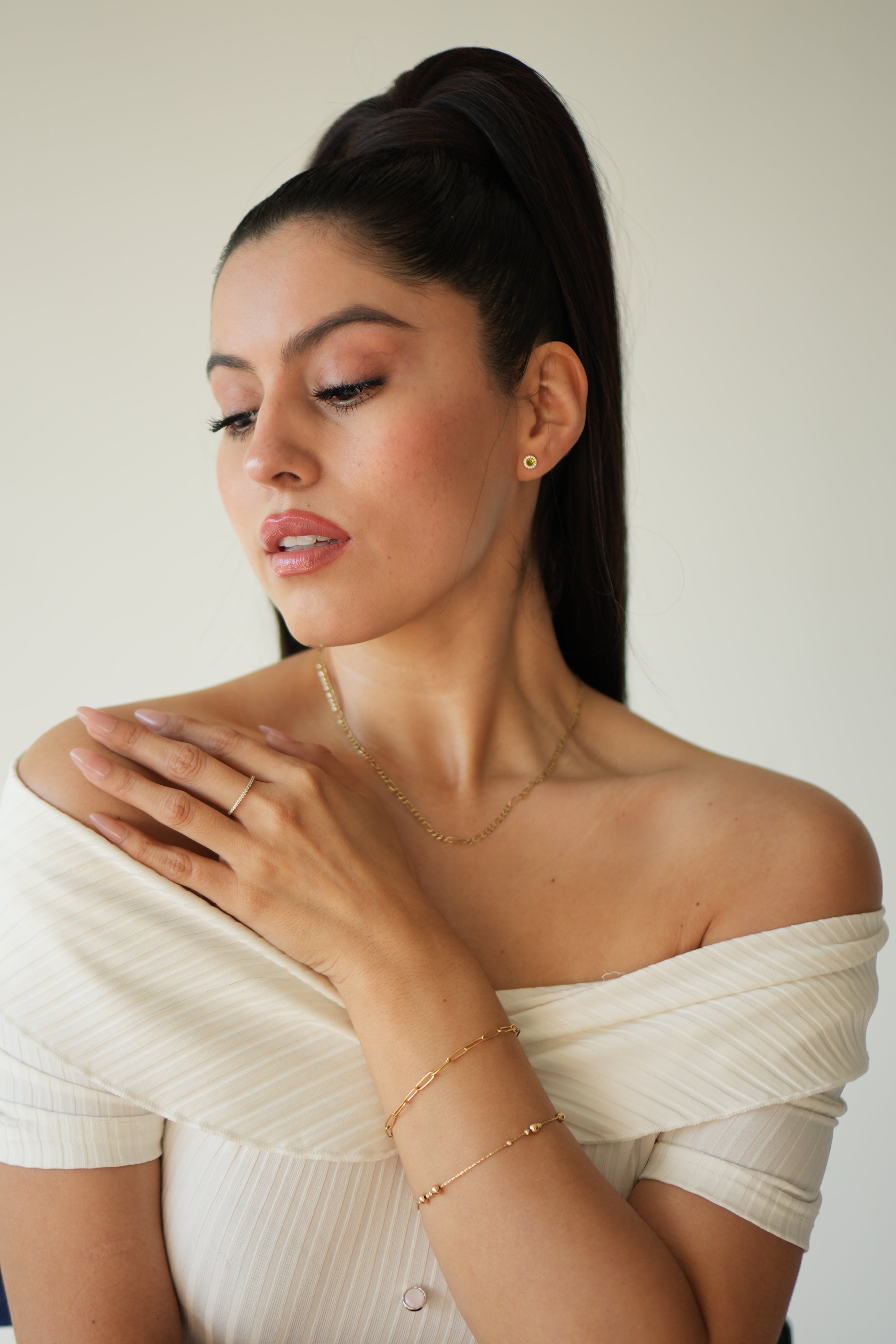Woman in a white dress lying on a white background