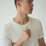 Person wearing a white tank top against a plain background