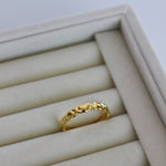 image of a gold heart ring on a ring tray on top of a marble table