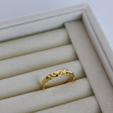 image of a gold heart ring on a ring tray on top of a marble table