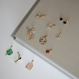Collection of gold earrings on a light gray surface