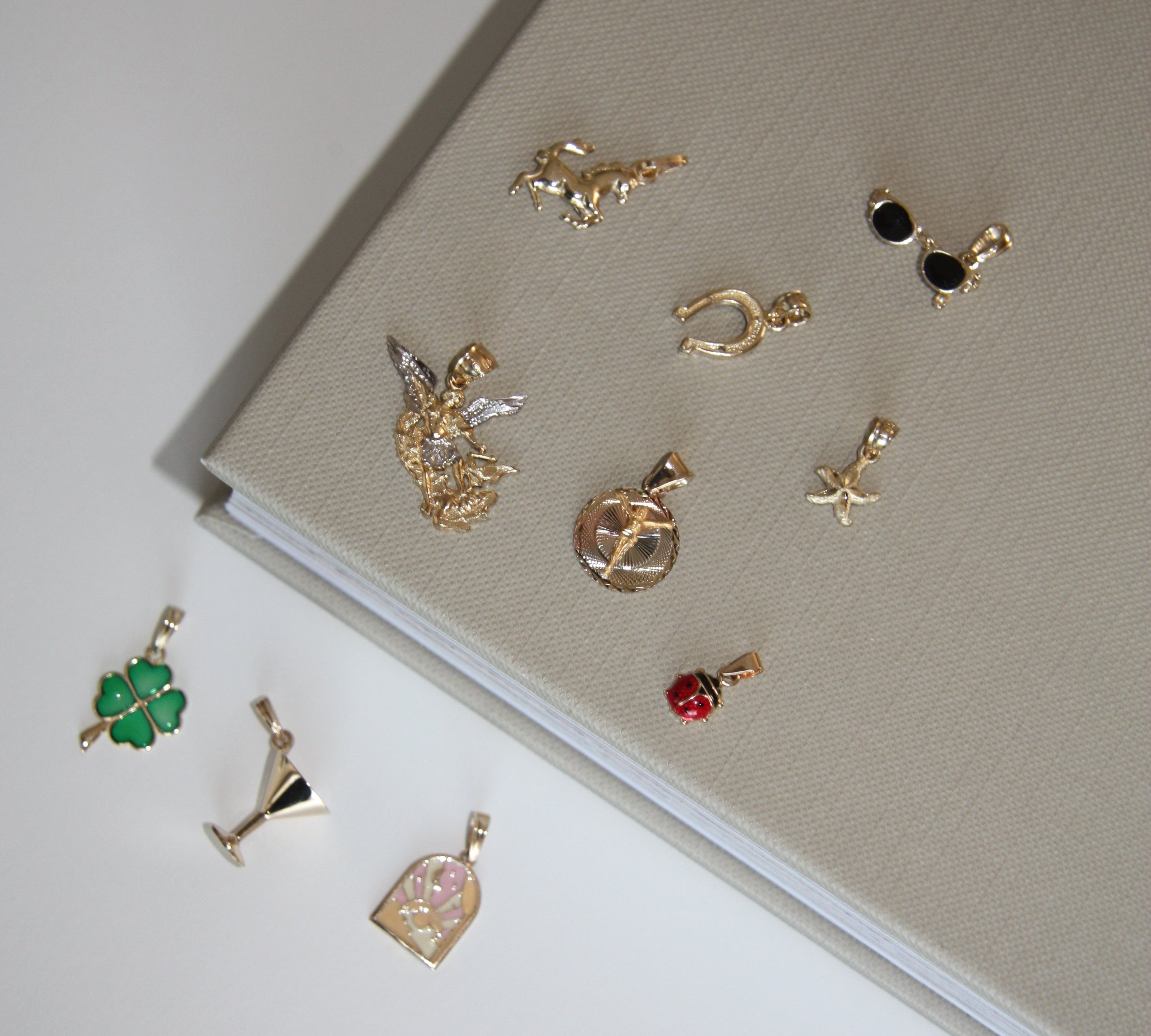 Collection of gold earrings on a light gray surface