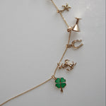 Necklace with various charms on a light gray background