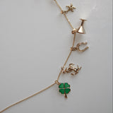 Necklace with various charms on a light gray background