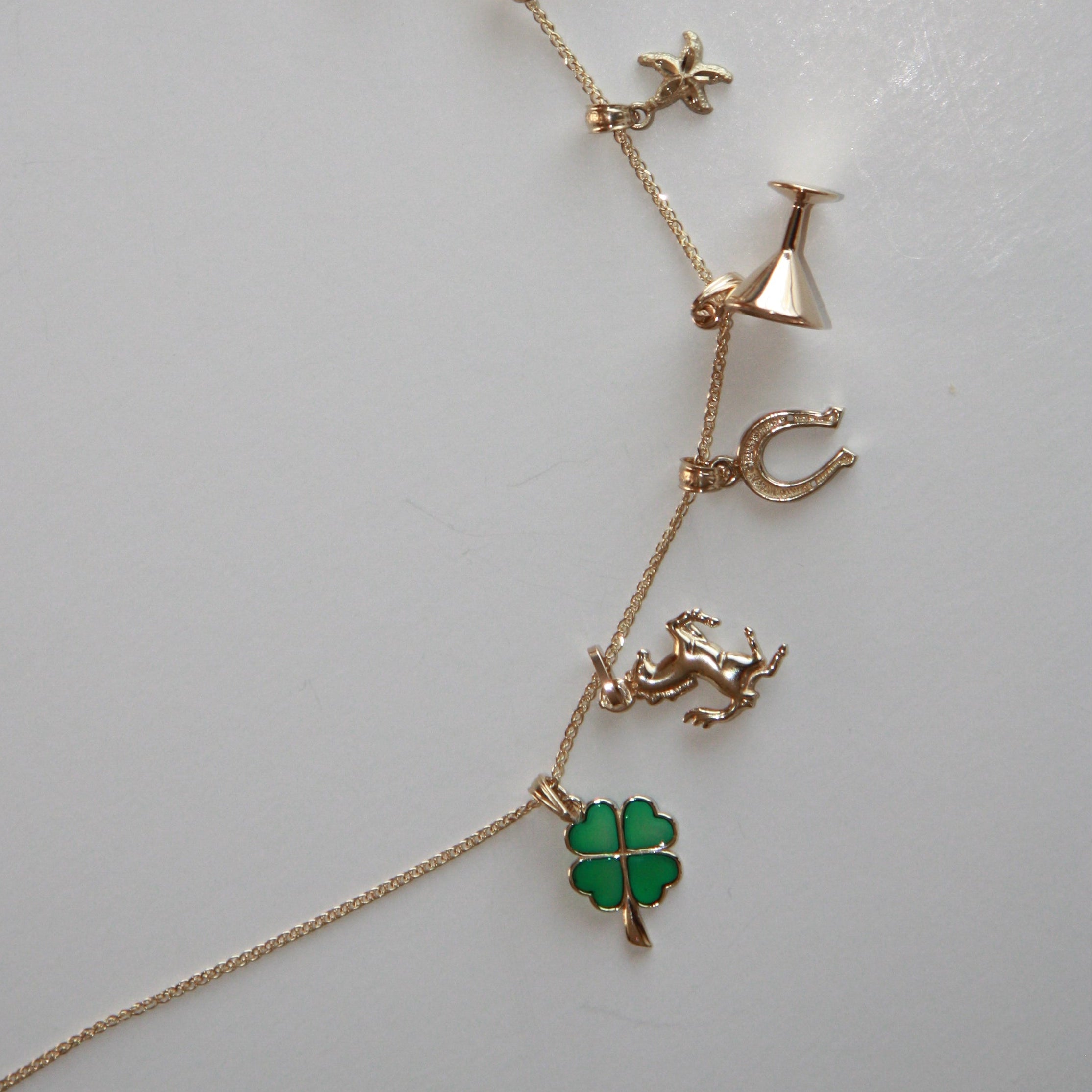 Necklace with various charms on a light gray background