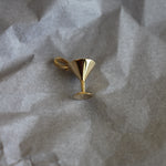 gold martini glass on gray paper