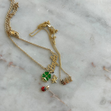 Gold necklace with charms on a marble surface