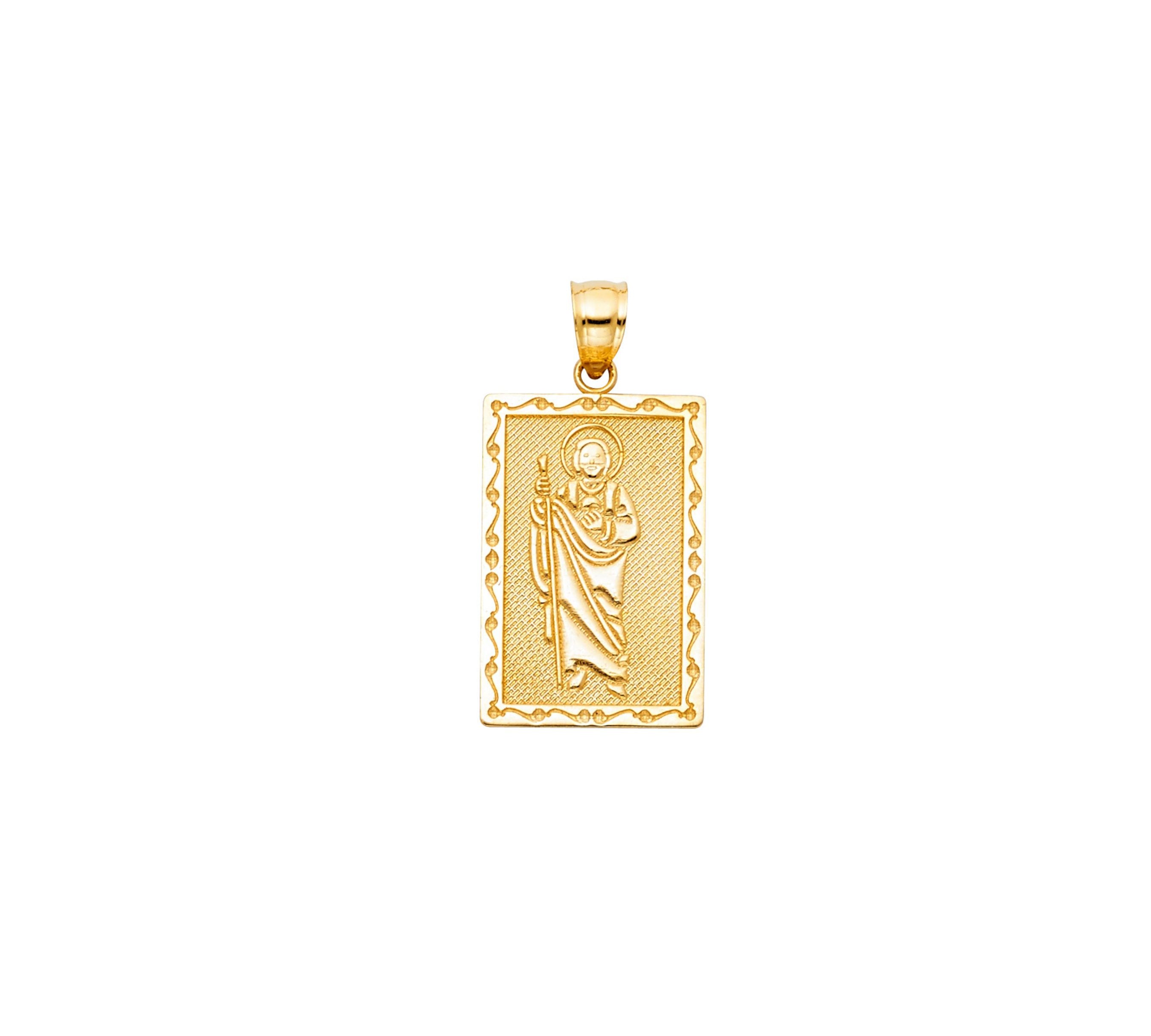 Gold pendant with a religious figure design on a white background