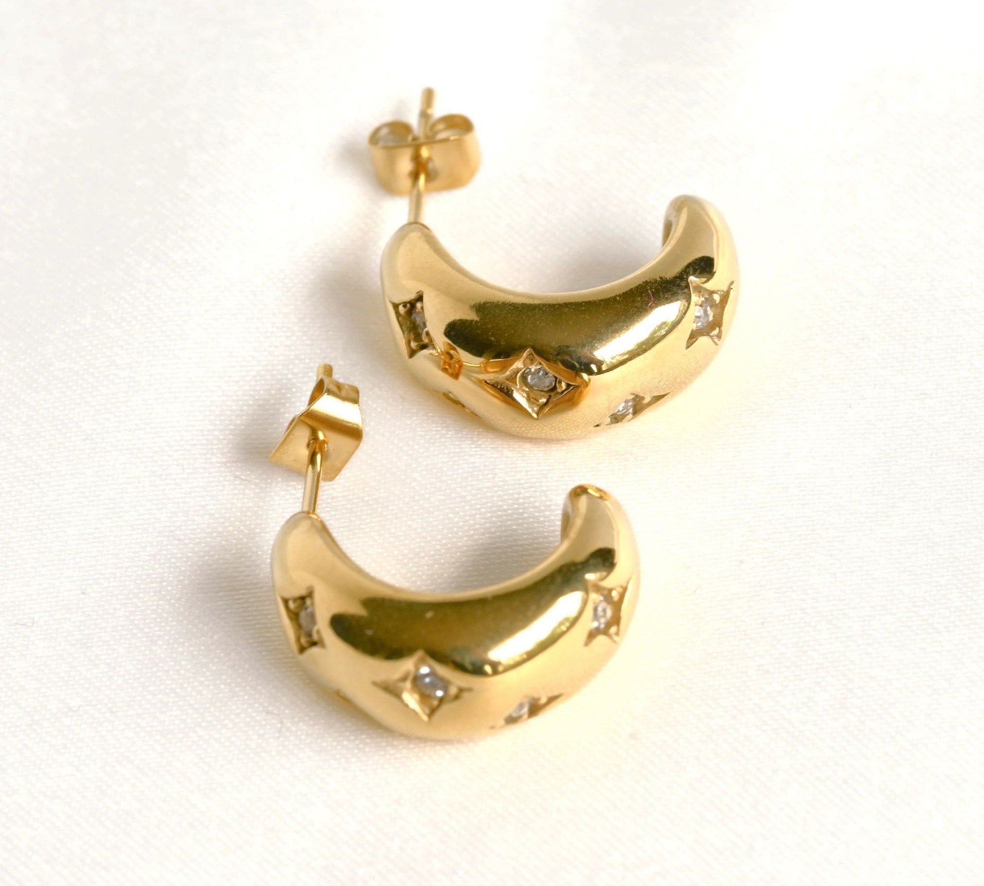 image of two gold earrings 