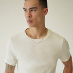 Man wearing a white t-shirt against a plain background
