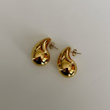 image of two teardrop earrings against a white backdrop