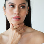Woman with a neutral expression against a white background