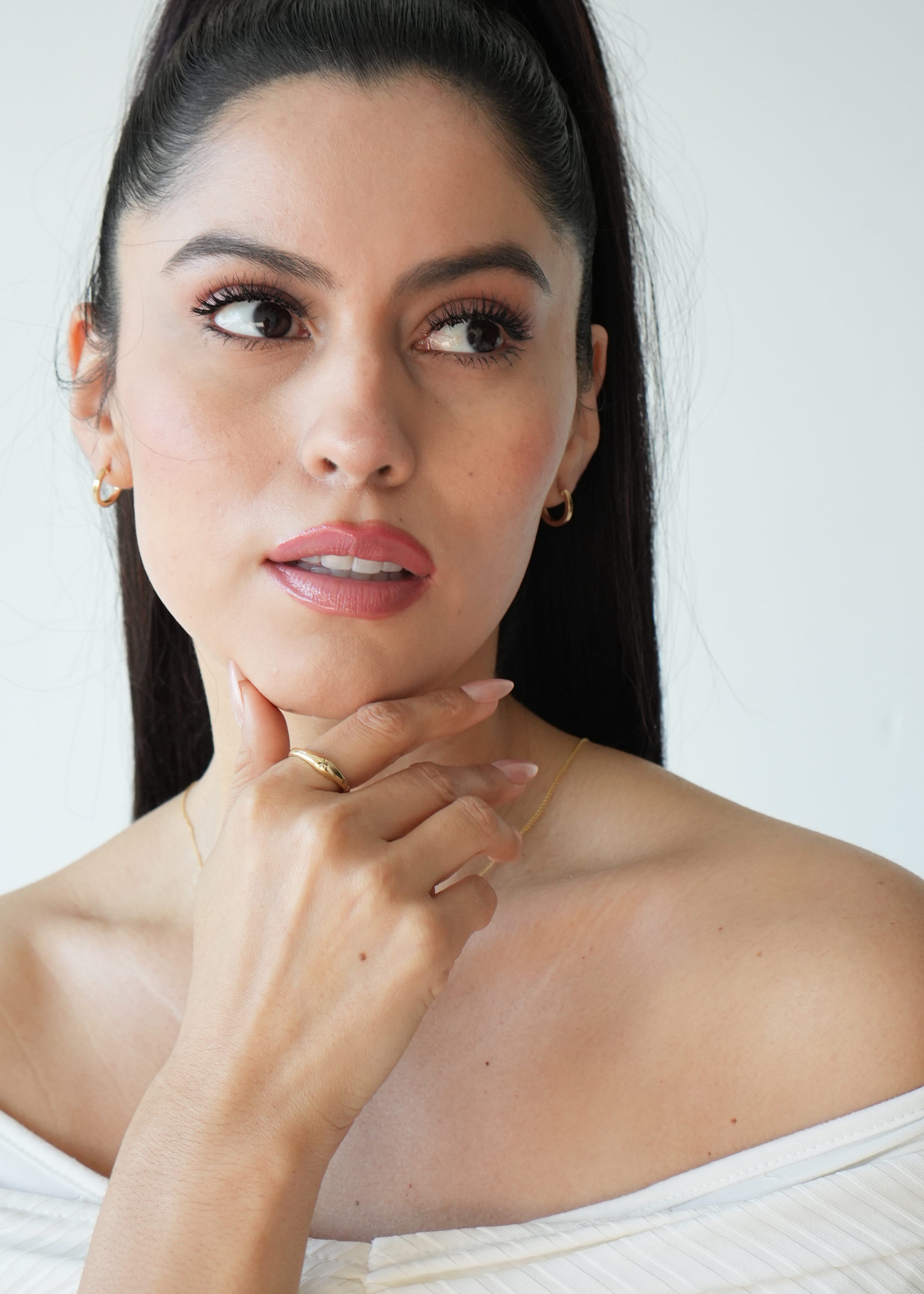Woman with a neutral expression against a white background