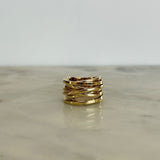 Gold ring on a reflective surface with a light gray background