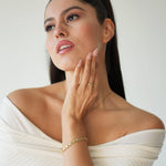 Woman in a white off-shoulder top with a neutral background