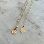 image of two gold angel pendant charms on a white backdrop