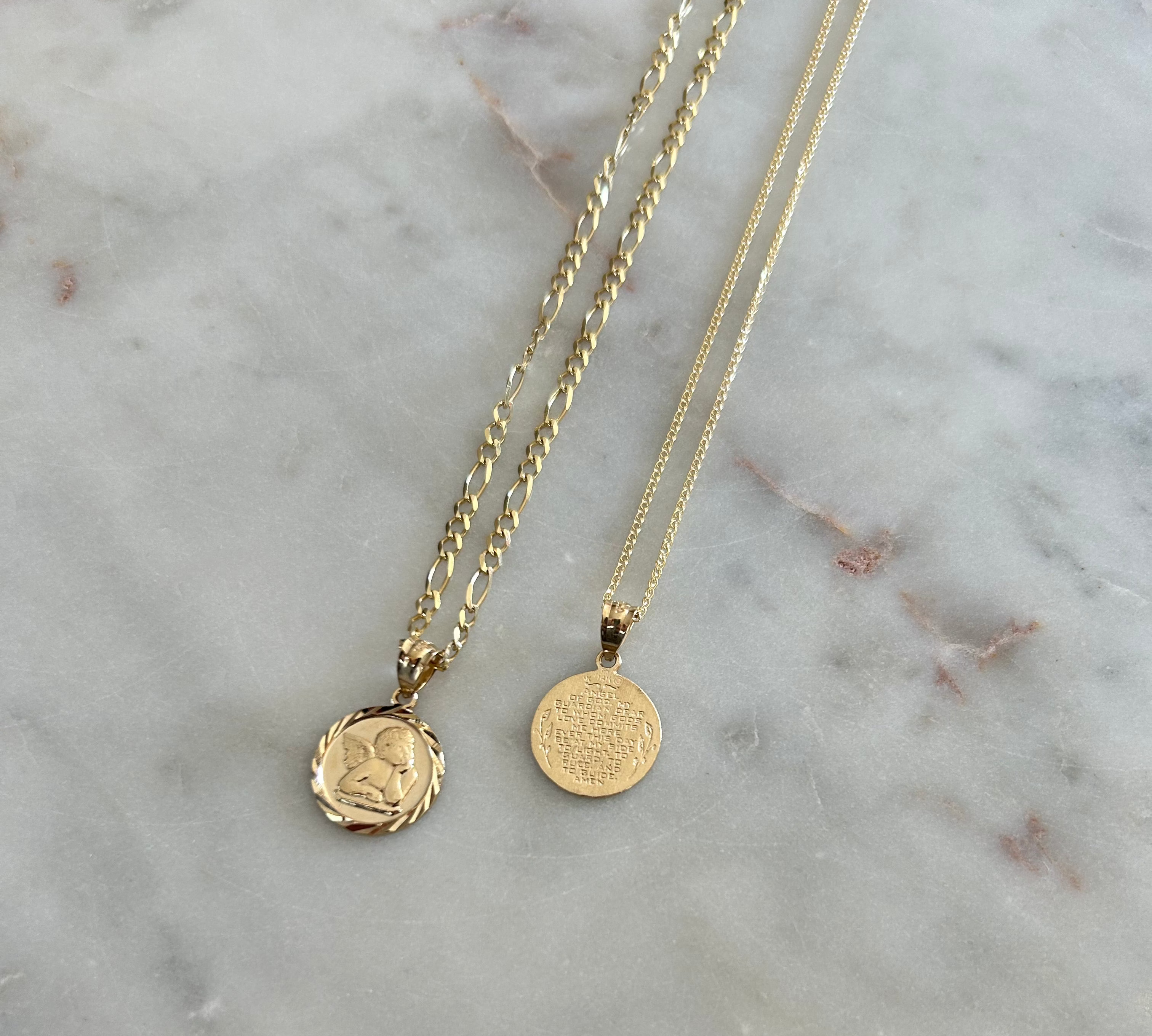 image of two gold angel pendant charms on a white backdrop