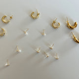 image of multiple earrings on a white backdrop