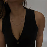 woman wearing gold figaro chain