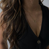 image of a woman wearing a gold heart necklace