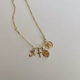 image of multiple gold pendant charms on a gold necklace