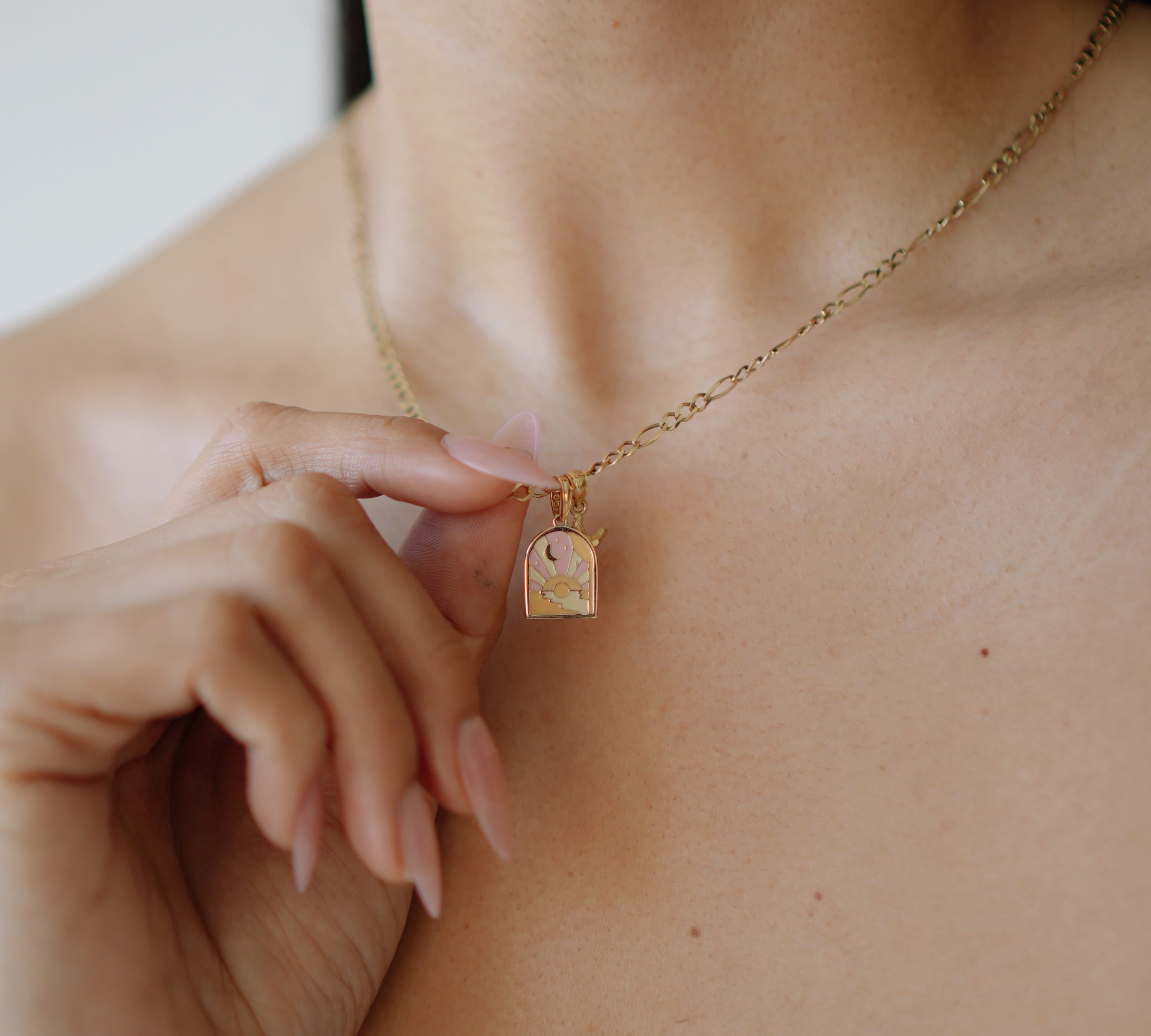 Necklace with a small square pendant worn by a person