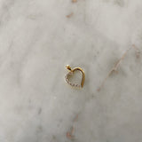 image of a two tone heart pendant on a marble table