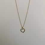 image of a two tone heart pendant and necklace on a white backdrop