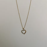 image of a two tone heart pendant and necklace on a white backdrop