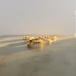 image of five gold pave ring on a marble table stacked on top of each other
