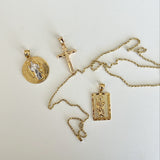 Gold necklaces with pendants on a white background