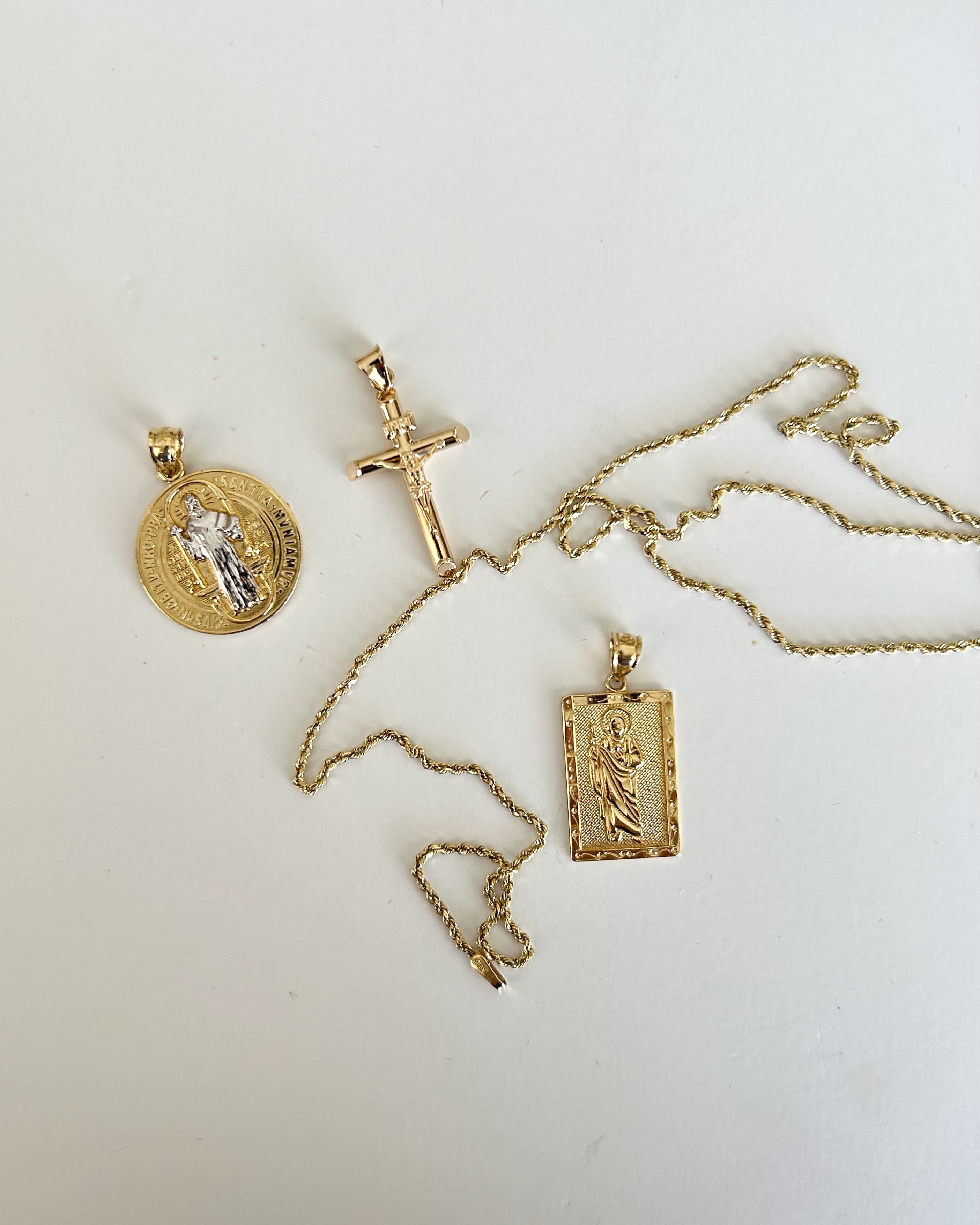Gold necklaces with pendants on a white background