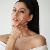 Woman in a white off-shoulder top with a plain background