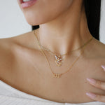 Close-up of a woman wearing gold necklaces with a blurred background