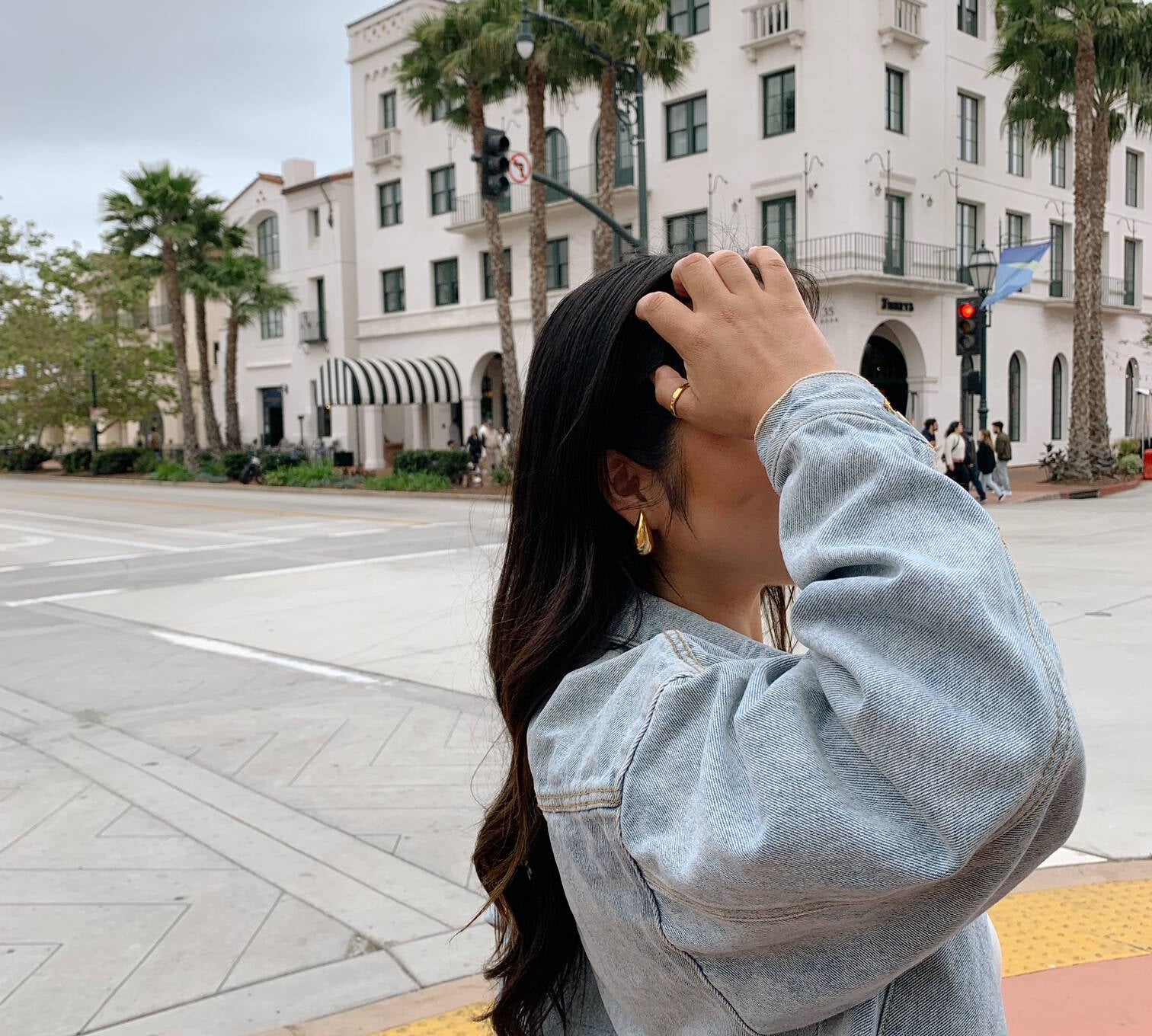 image of a women pushing hair back on a californian street