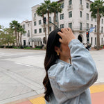 image of a women pushing hair back on a californian street